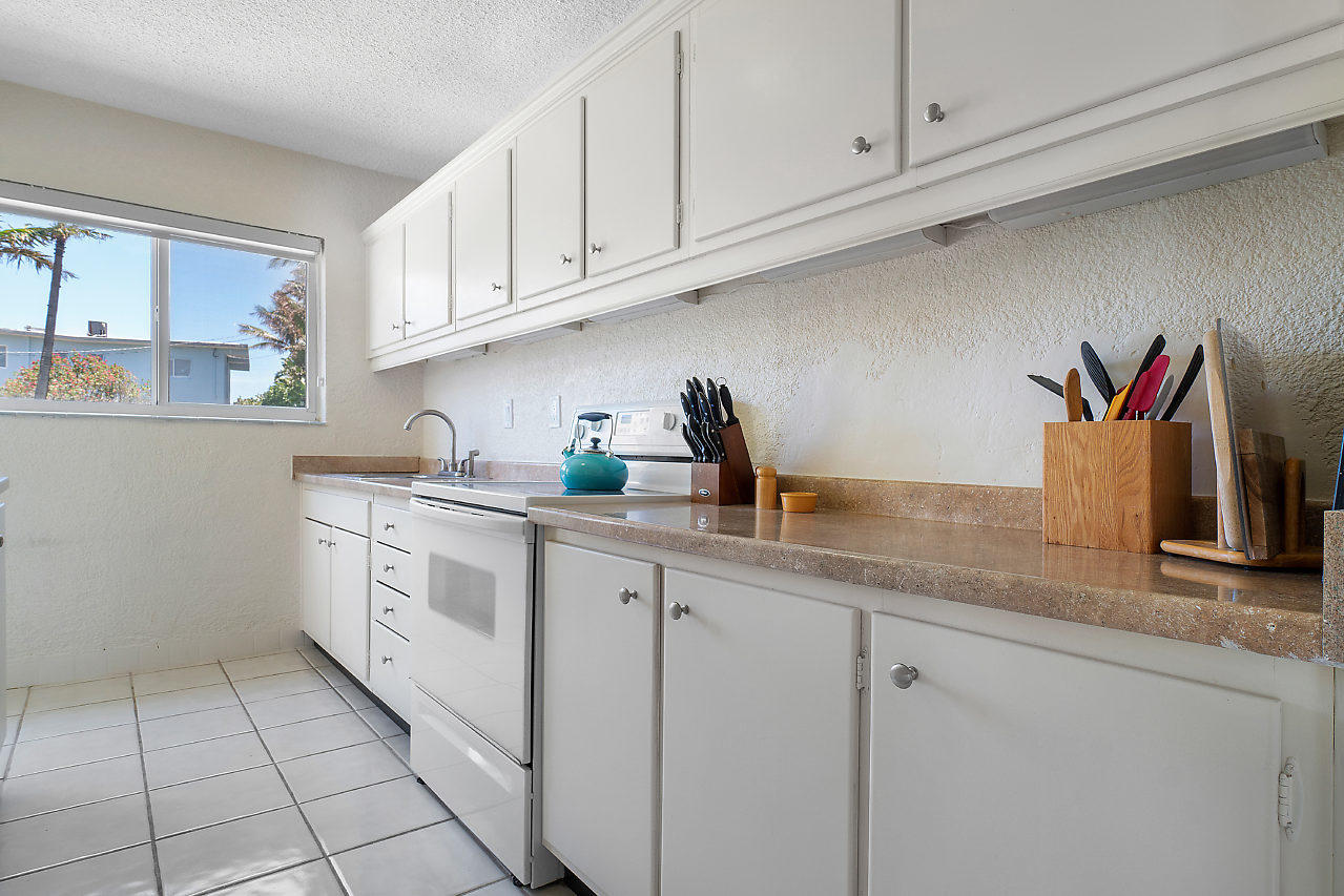 5700 Old Ocean Boulevard, Unit V Ocean Ridge, FL 33435 - Photo 14 of 24 a kitchen with granite countertop white cabinets and a sink