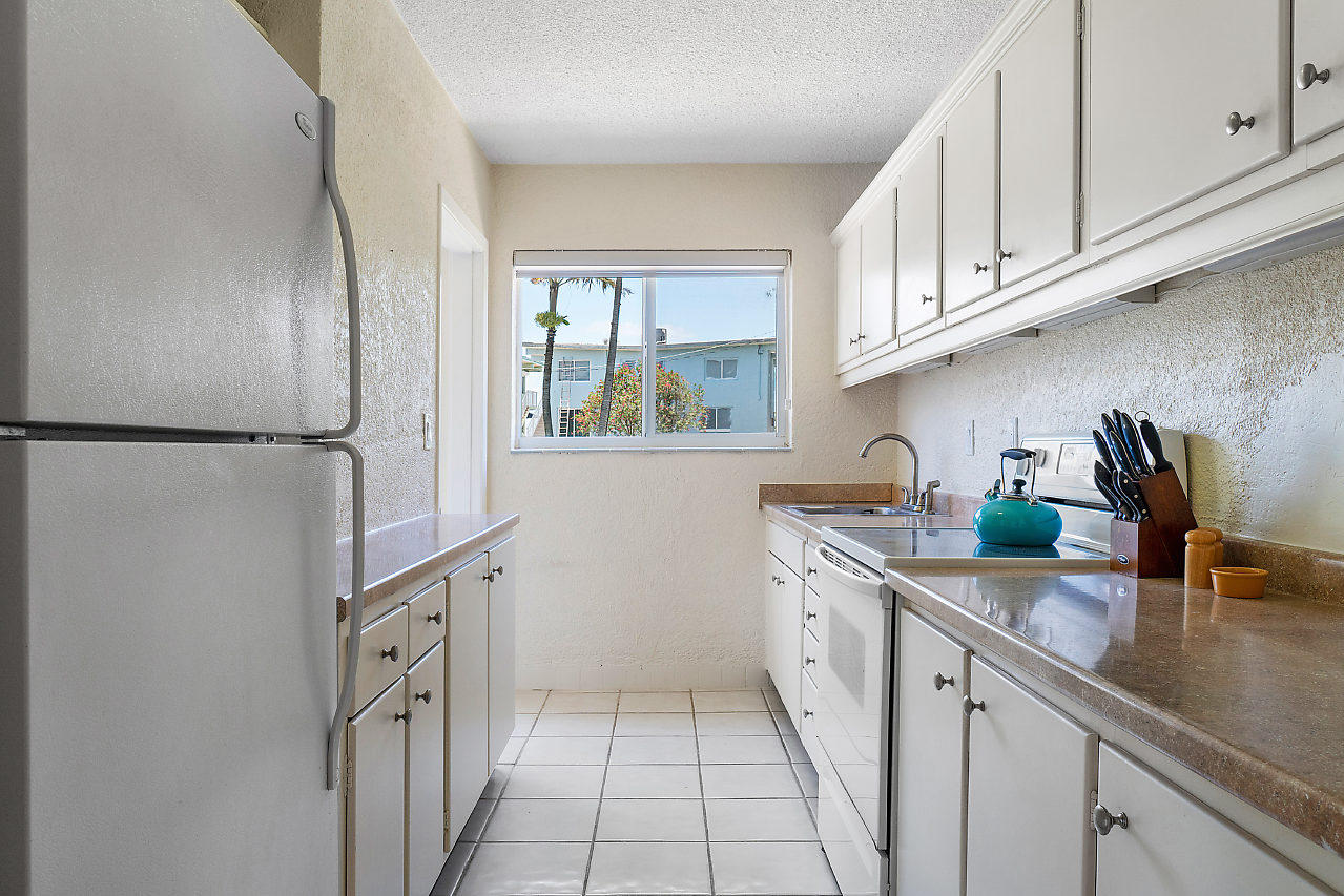 5700 Old Ocean Boulevard, Unit V Ocean Ridge, FL 33435 - Photo 15 of 24 a kitchen with stainless steel appliances granite countertop a sink and a refrigerator