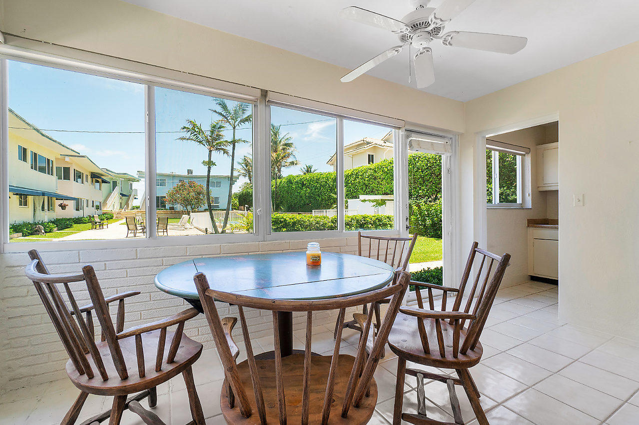 5700 Old Ocean Boulevard, Unit V Ocean Ridge, FL 33435 - Photo 22 of 24 a dining room with furniture a chandelier and wooden floor