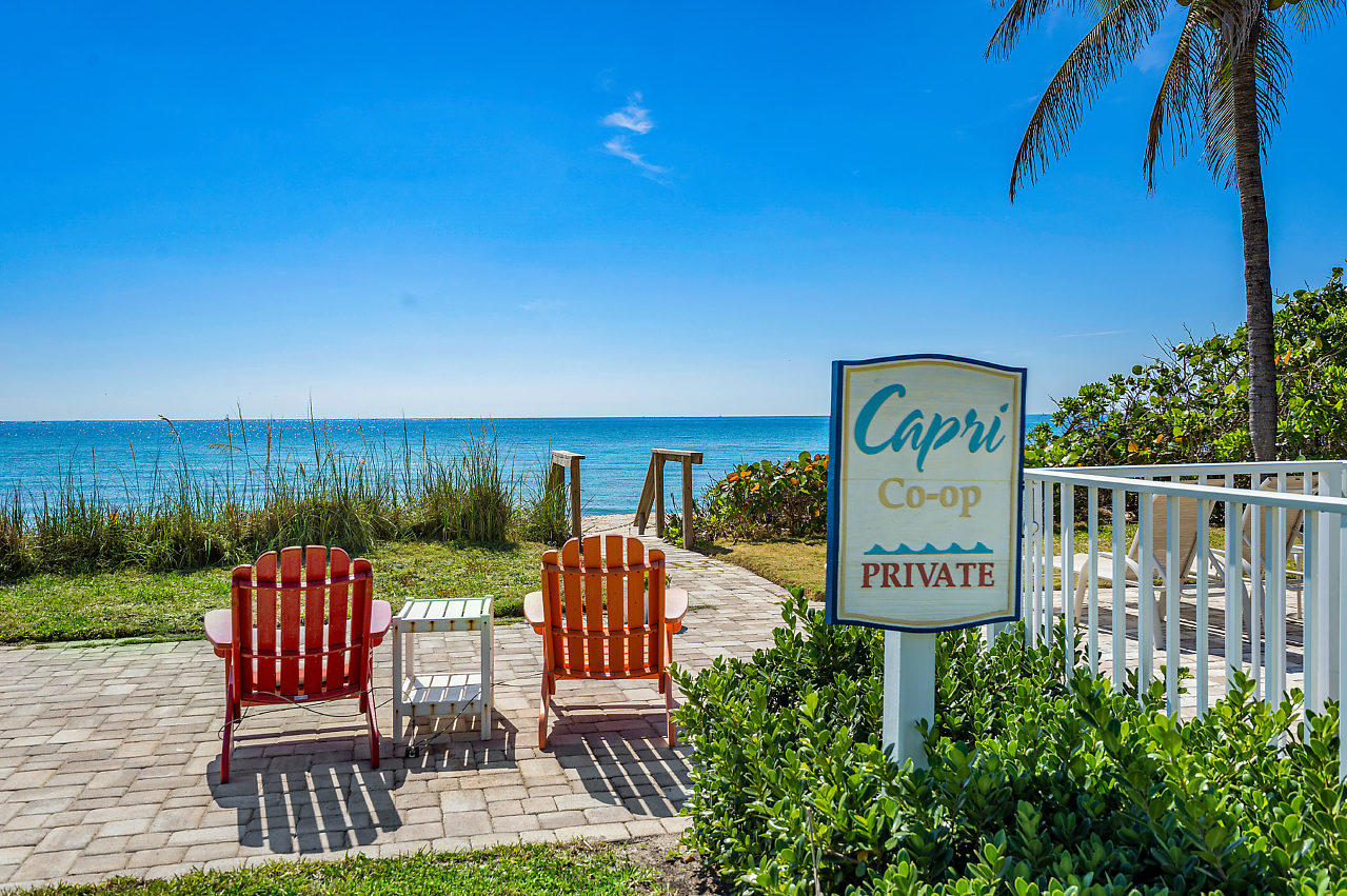 5700 Old Ocean Boulevard, Unit V Ocean Ridge, FL 33435 - Photo 6 of 24 a view of a chairs and table in patio with wooden fence
