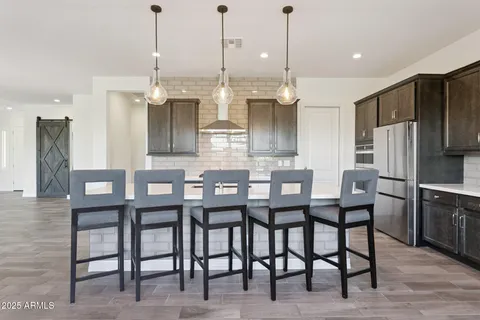 a kitchen with a sink a counter space and wooden floor