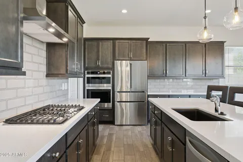 a kitchen with a sink stove and refrigerator