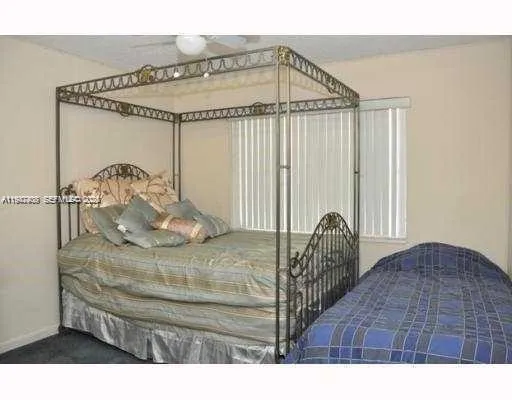 a bedroom with a bed and a mirror