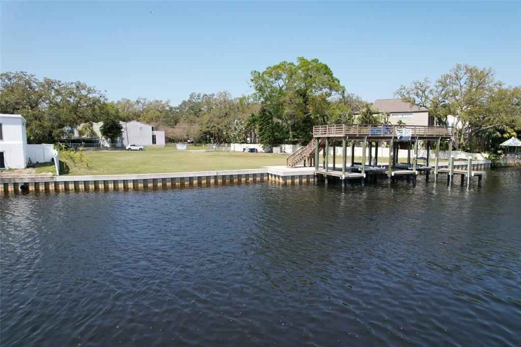 4033 North River View Avenue Tampa, FL 33607 - Photo 58 of 66 a view of swimming pool with outdoor seating and lake view