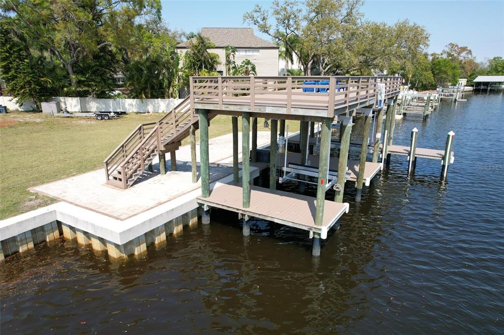 4033 North River View Avenue Tampa, FL 33607 - Photo 64 of 66 a view of a swimming pool with outdoor seating and plants