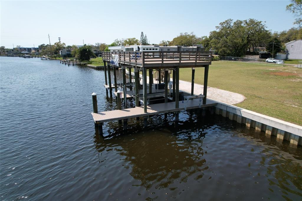 4033 North River View Avenue Tampa, FL 33607 - Photo 65 of 66 a view of a lake with a bench in front of house
