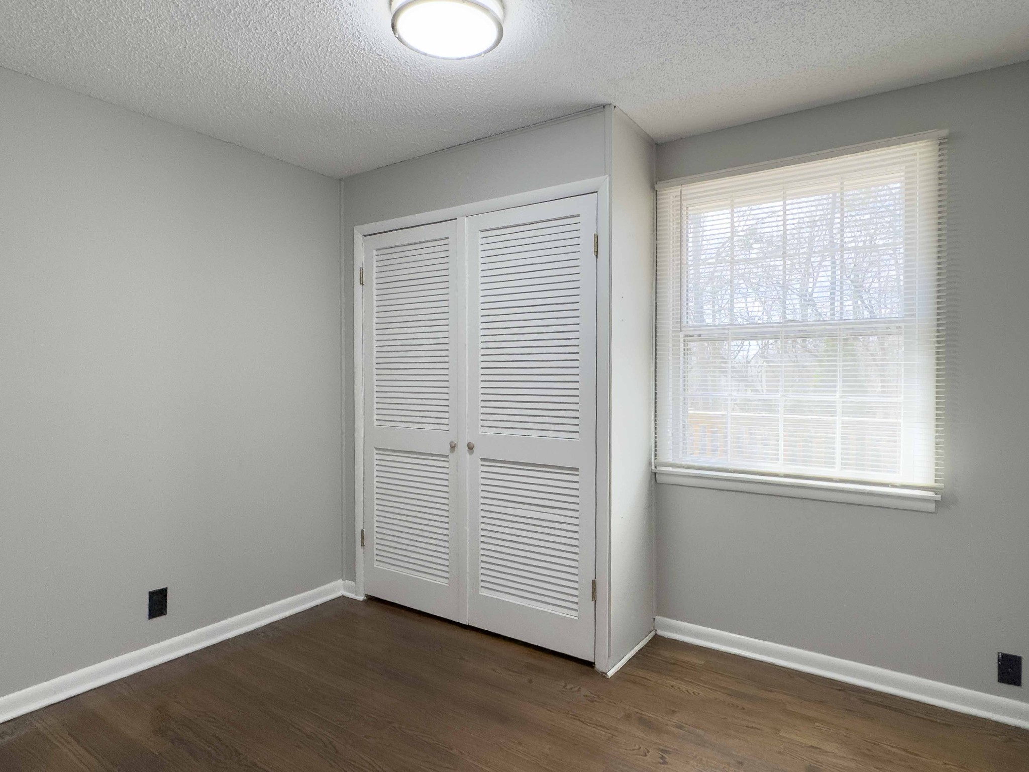 328 Dunbar Cave Road Clarksville, TN 37043 - Photo 15 of 26 an empty room with wooden floor and windows