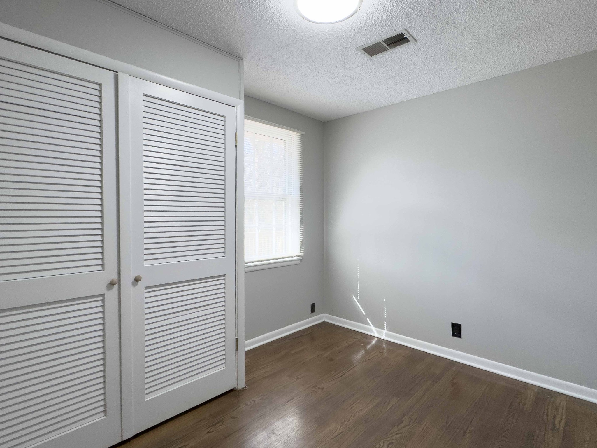 328 Dunbar Cave Road Clarksville, TN 37043 - Photo 17 of 26 wooden floor in an empty room with a window