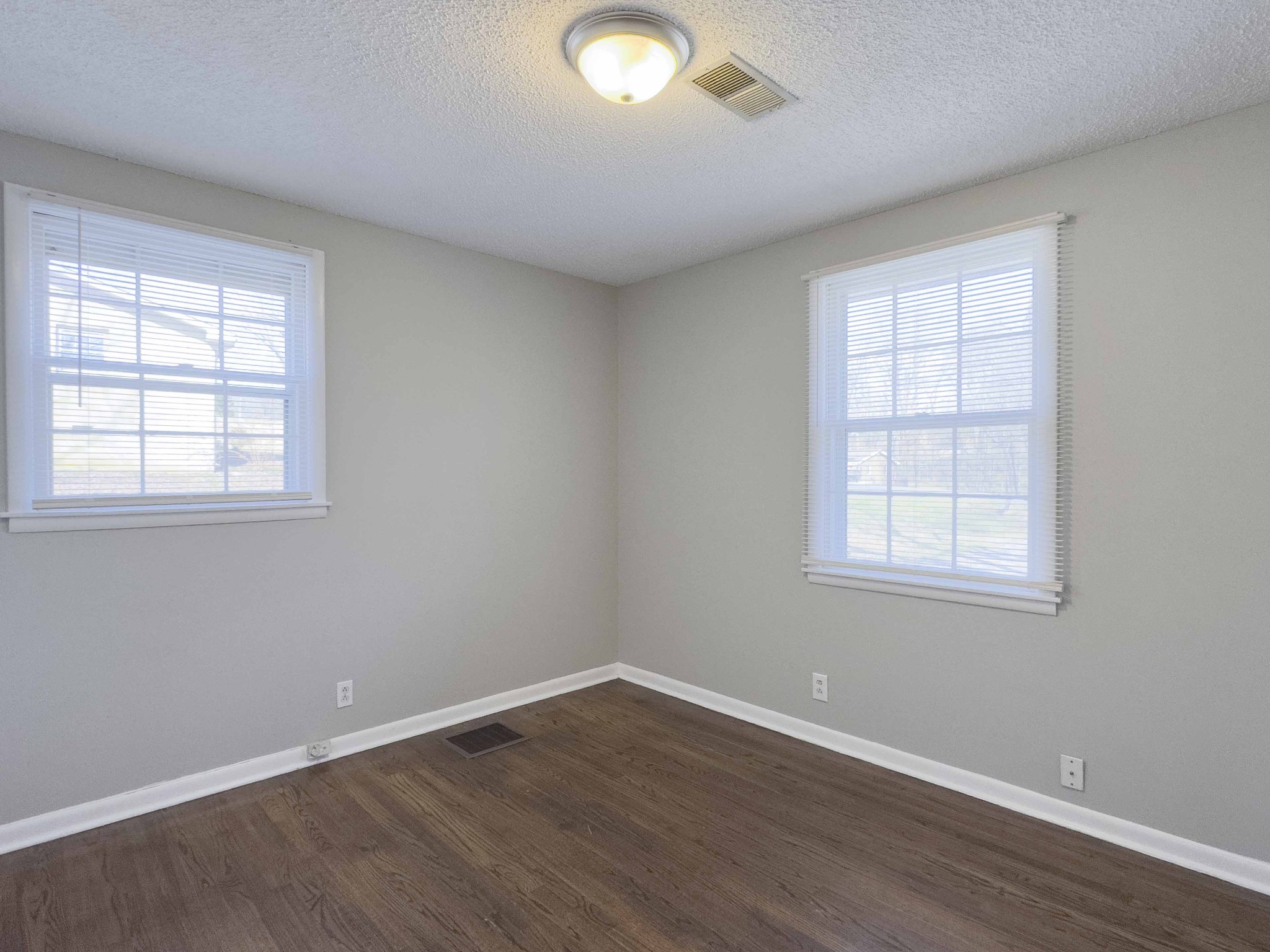 328 Dunbar Cave Road Clarksville, TN 37043 - Photo 18 of 26 an empty room with wooden floor and windows