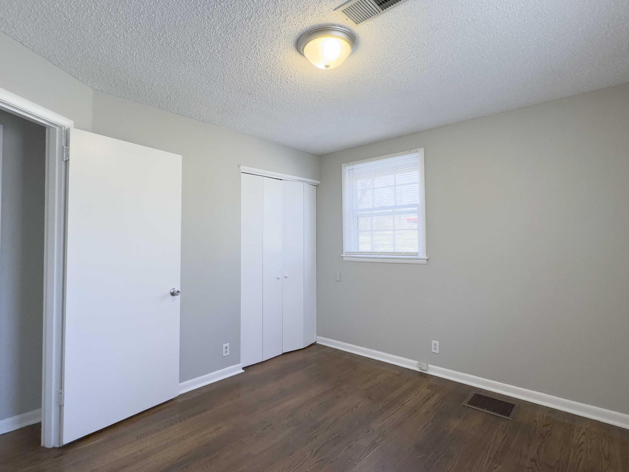 328 Dunbar Cave Road Clarksville, TN 37043 - Photo 19 of 26 an empty room with wooden floor and windows