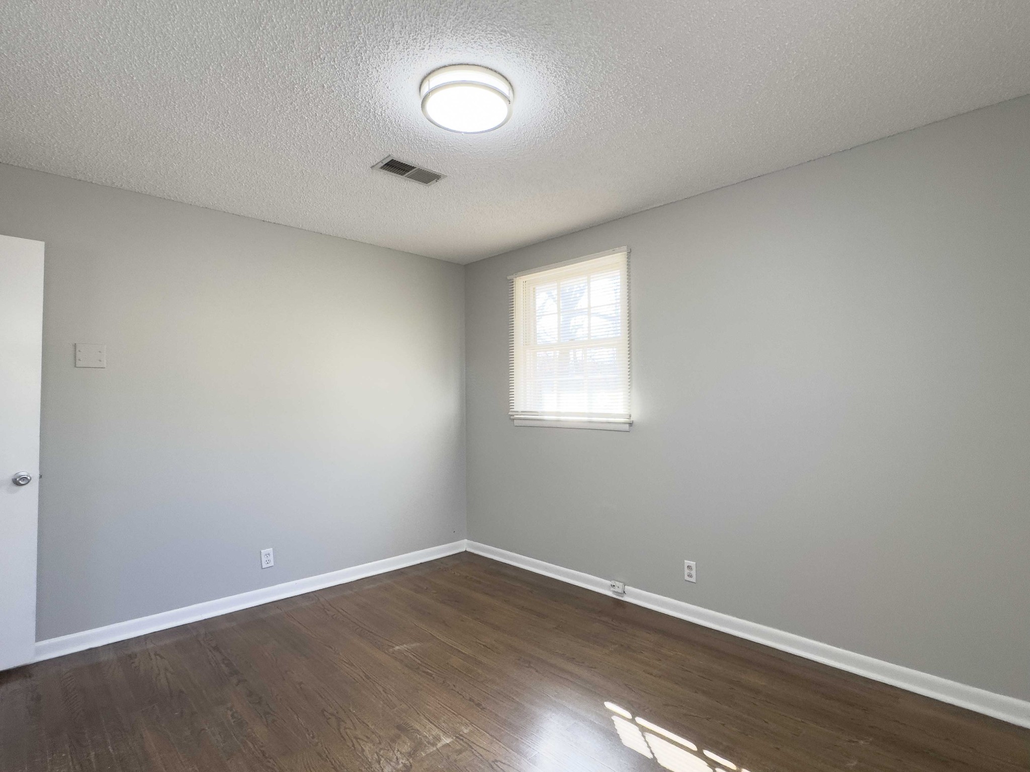 328 Dunbar Cave Road Clarksville, TN 37043 - Photo 22 of 26 an empty room with wooden floor and windows