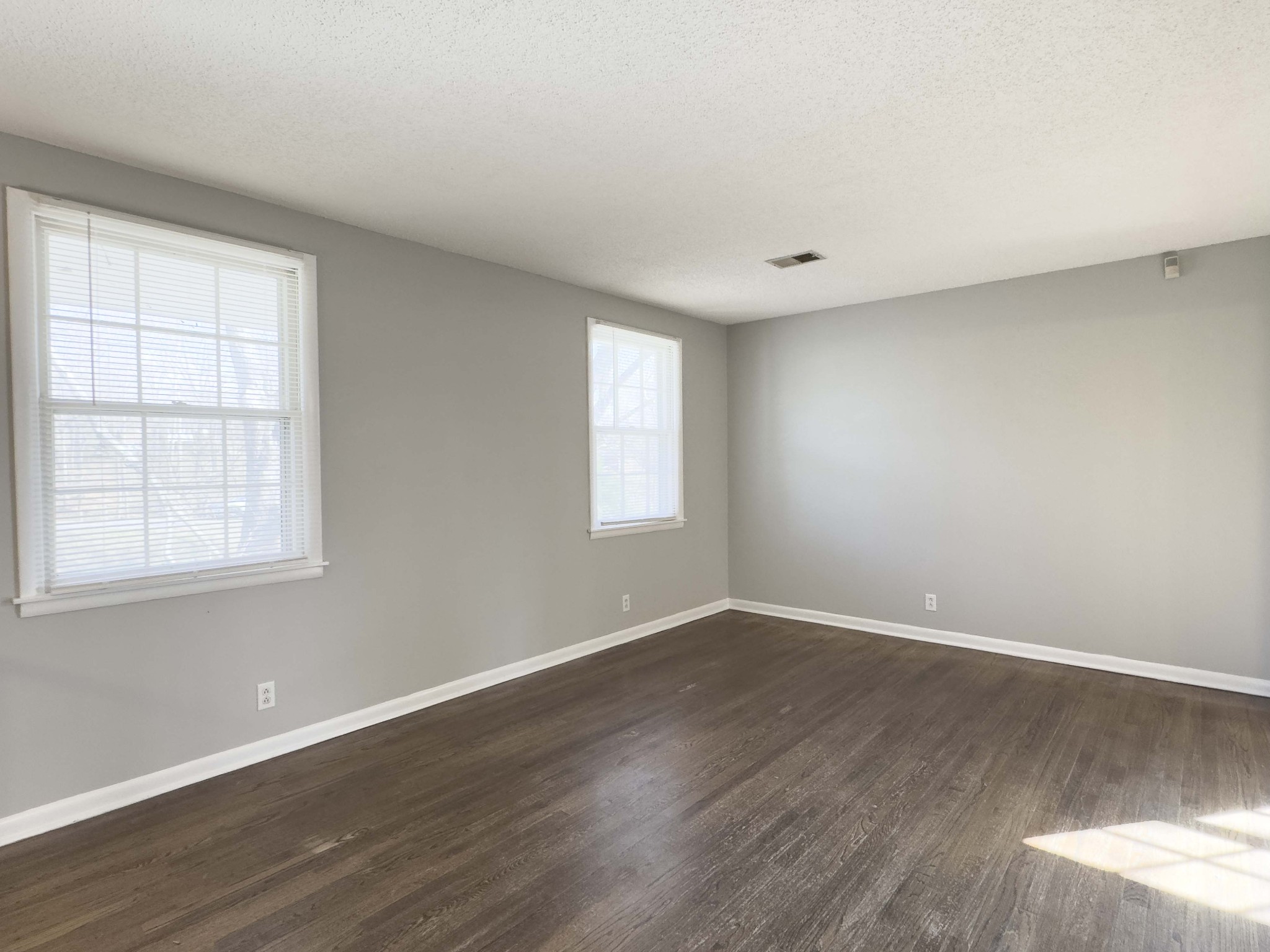 328 Dunbar Cave Road Clarksville, TN 37043 - Photo 5 of 26 a view of an empty room with wooden floor and a window