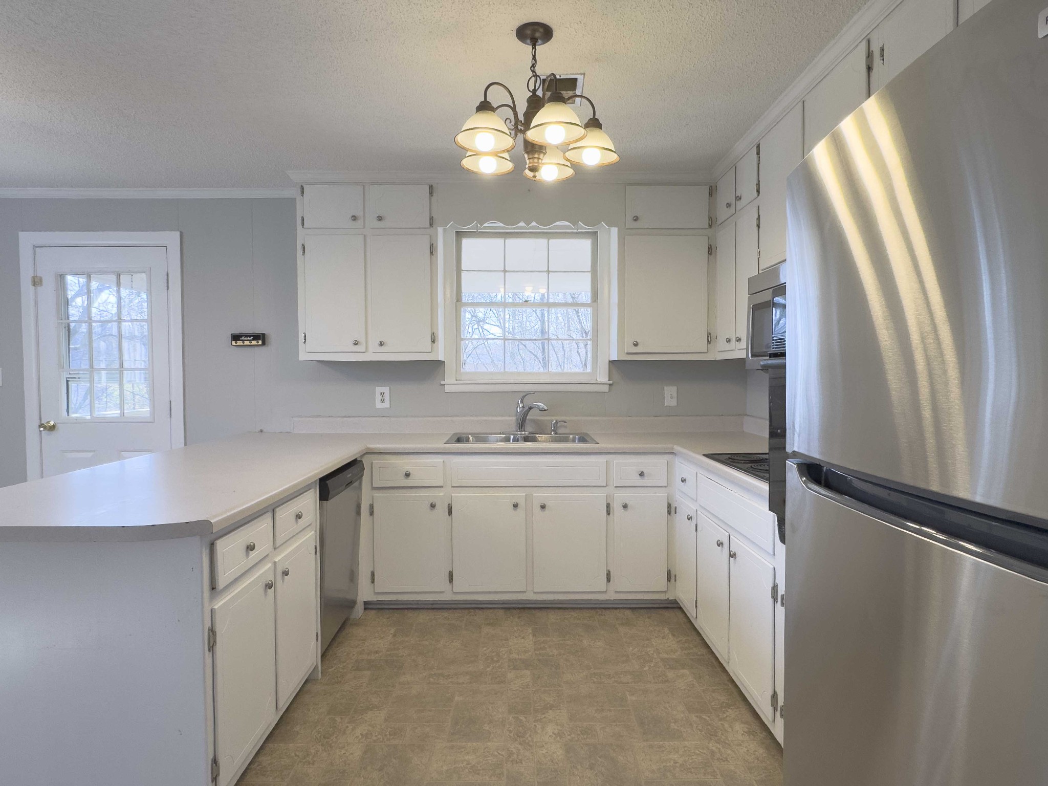 328 Dunbar Cave Road Clarksville, TN 37043 - Photo 7 of 26 a kitchen with granite countertop a sink stove and refrigerator