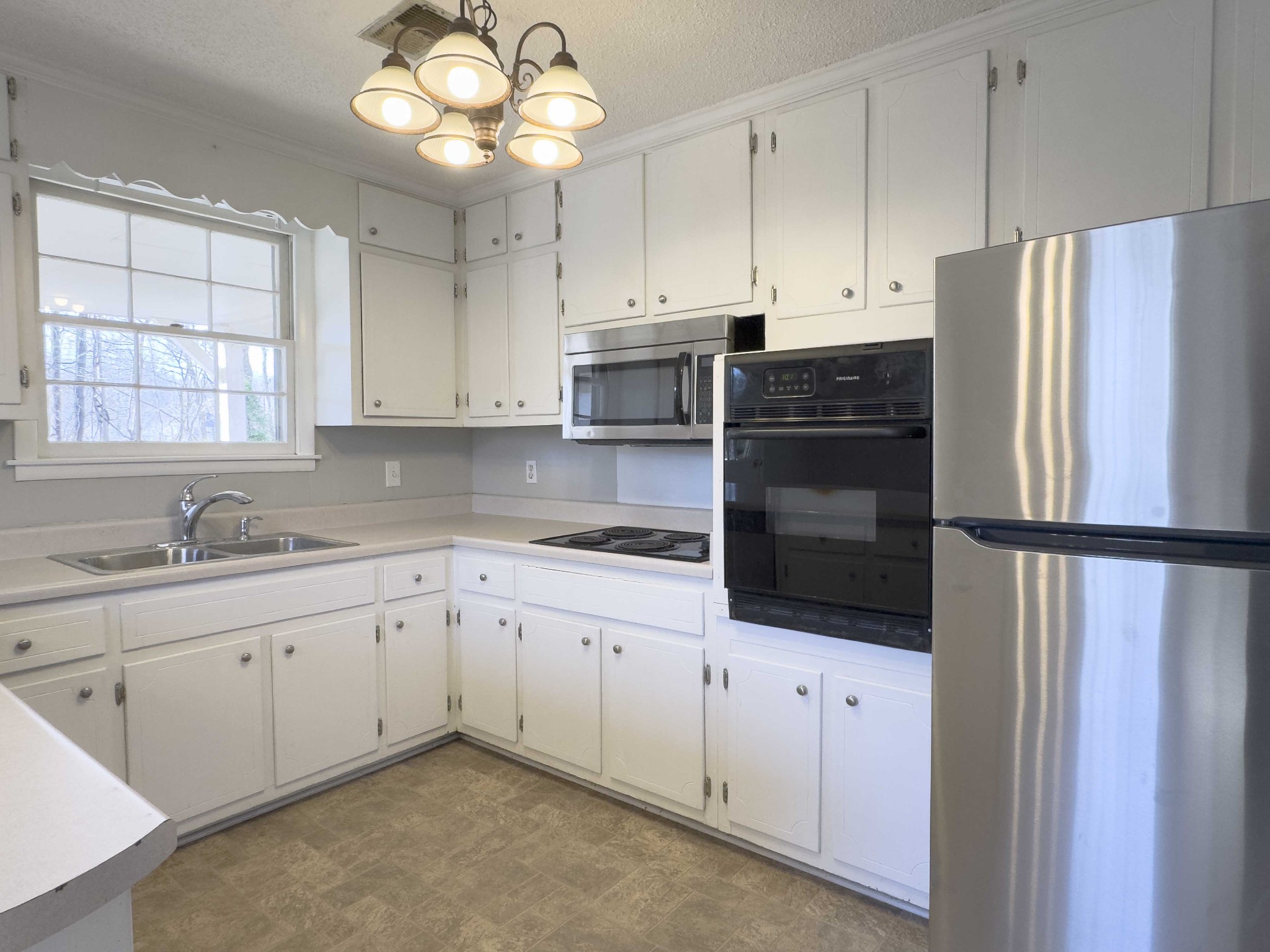 328 Dunbar Cave Road Clarksville, TN 37043 - Photo 8 of 26 a kitchen with stainless steel appliances a refrigerator sink and cabinets