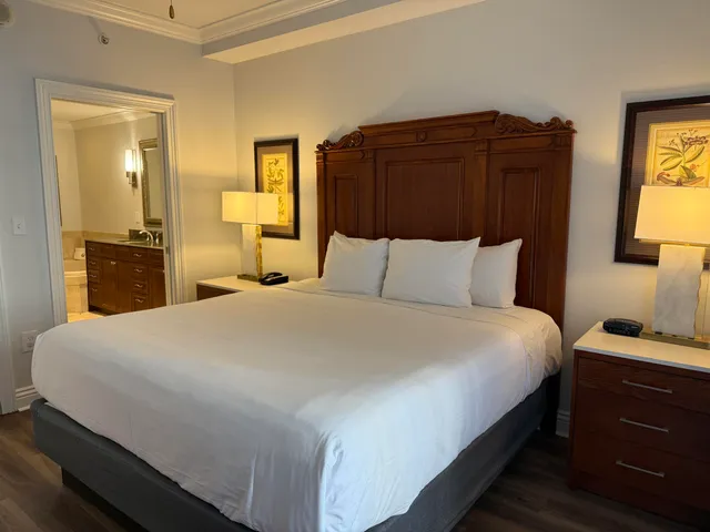 a bathroom with a granite countertop tub double vanity sink and a mirror