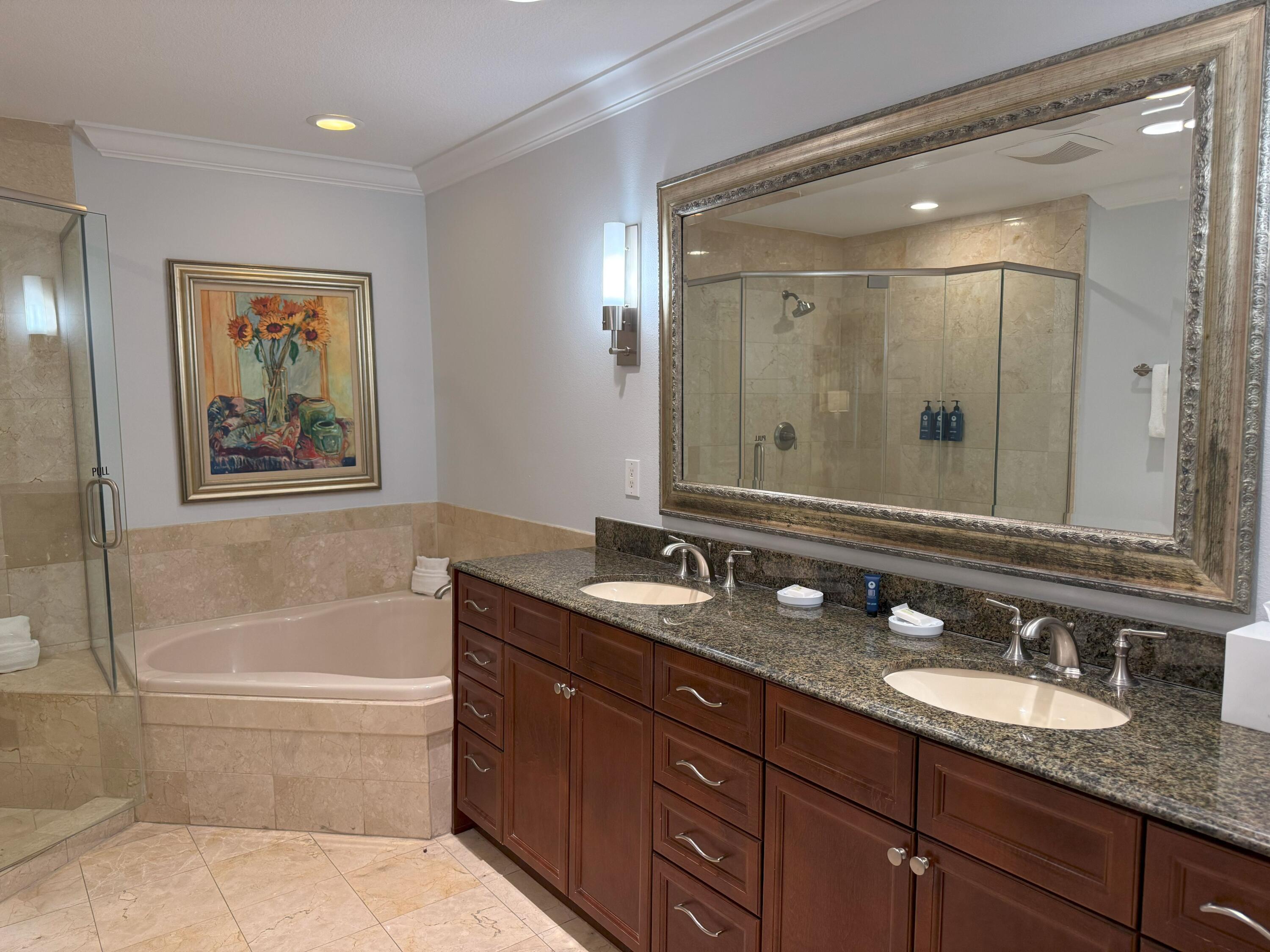 10 Harbor Boulevard, Unit E102F Destin, FL 32541 - Photo 13 of 29 a bathroom with a granite countertop tub double vanity sink and a mirror