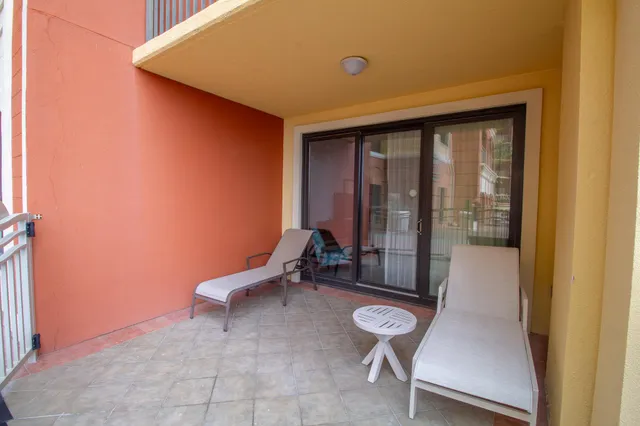 a room with wooden chairs and a glass door