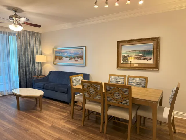 a view of a dining room with furniture and a chandelier