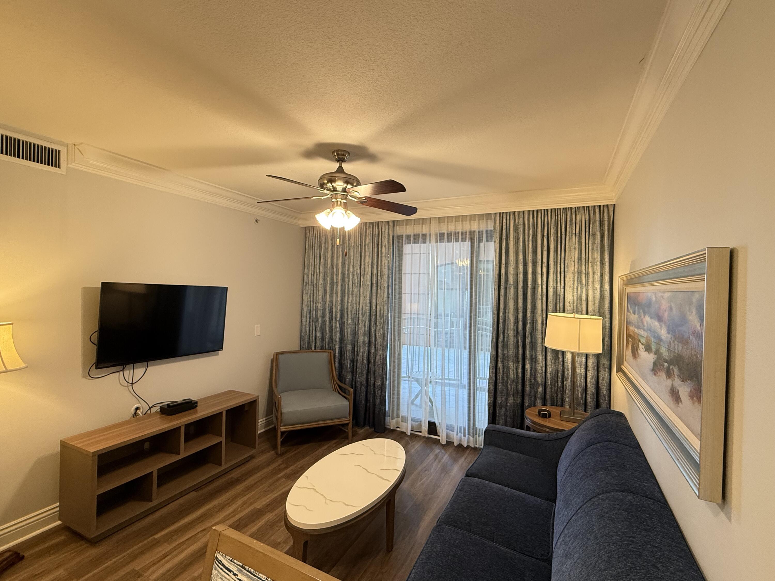 10 Harbor Boulevard, Unit E102F Destin, FL 32541 - Photo 4 of 29 a living room with furniture and a flat screen tv