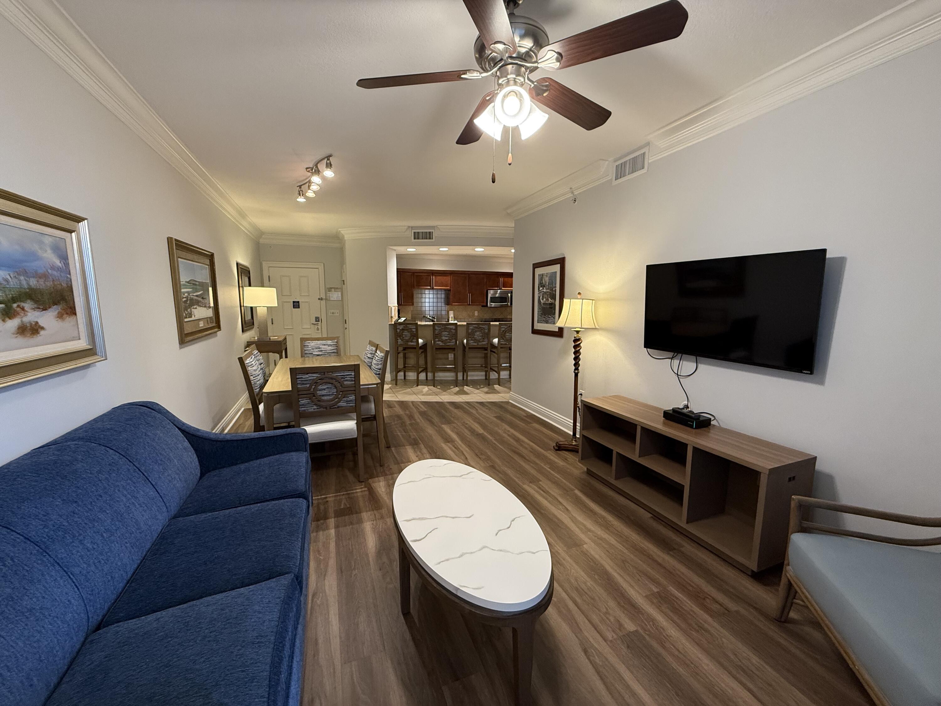 10 Harbor Boulevard, Unit E102F Destin, FL 32541 - Photo 5 of 29 a living room with furniture and a flat screen tv