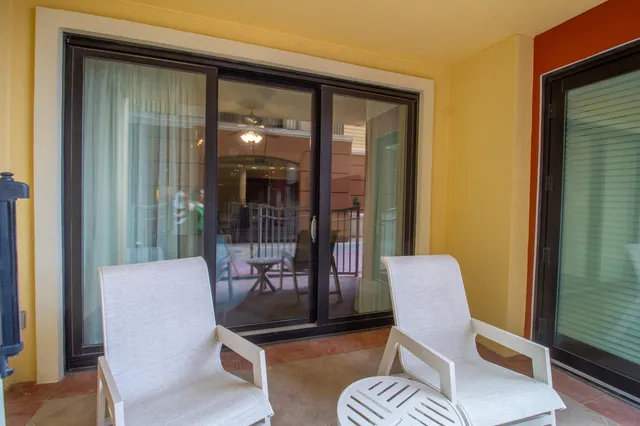 a kitchen with stainless steel appliances granite countertop a sink a stove a refrigerator cabinets and chairs