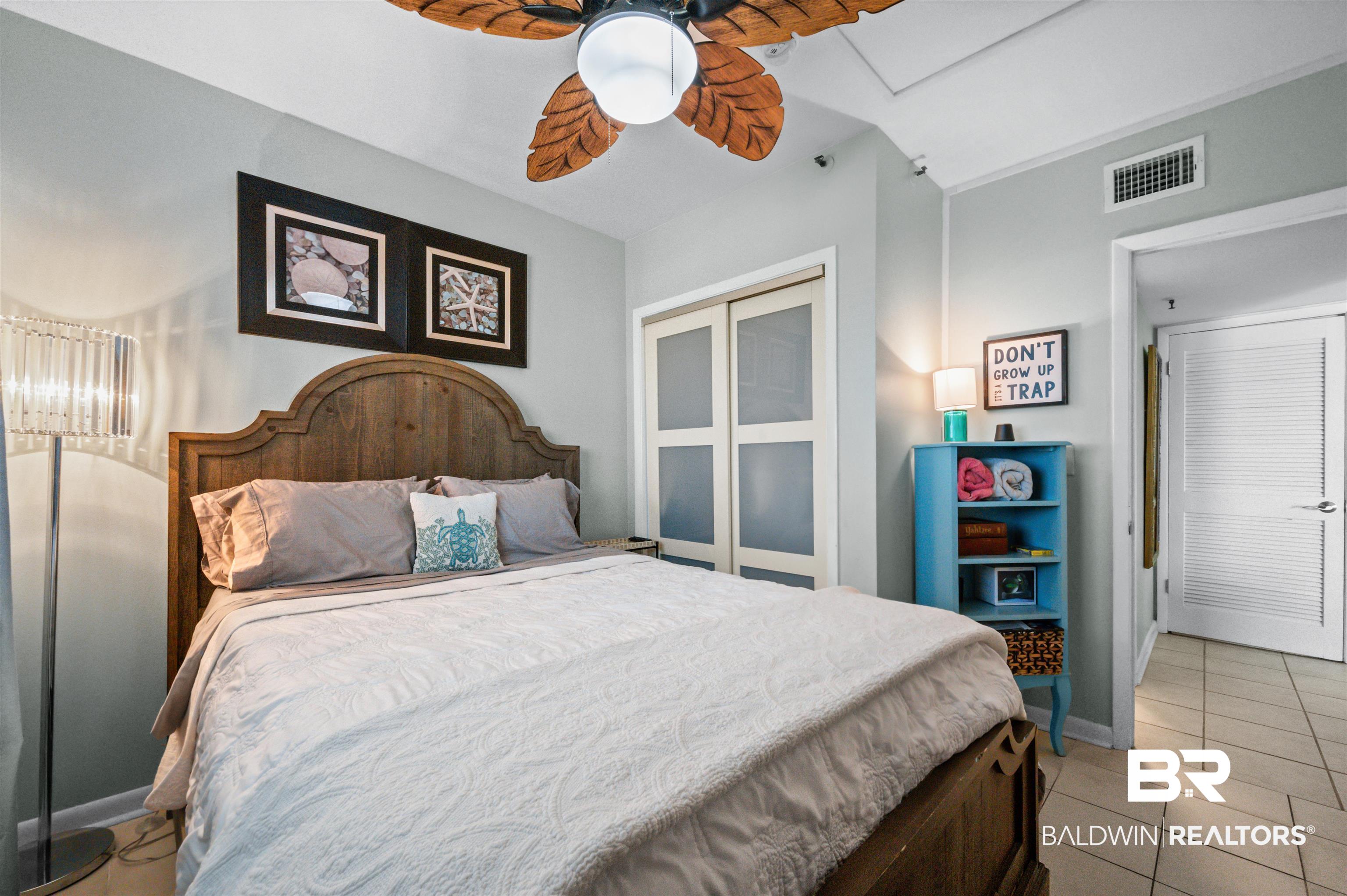 375 Plantation Road, Unit 5610 Gulf Shores, AL 36542 - Photo 12 of 33 Bedroom featuring light tile patterned floors, a closet, and a ceiling fan
