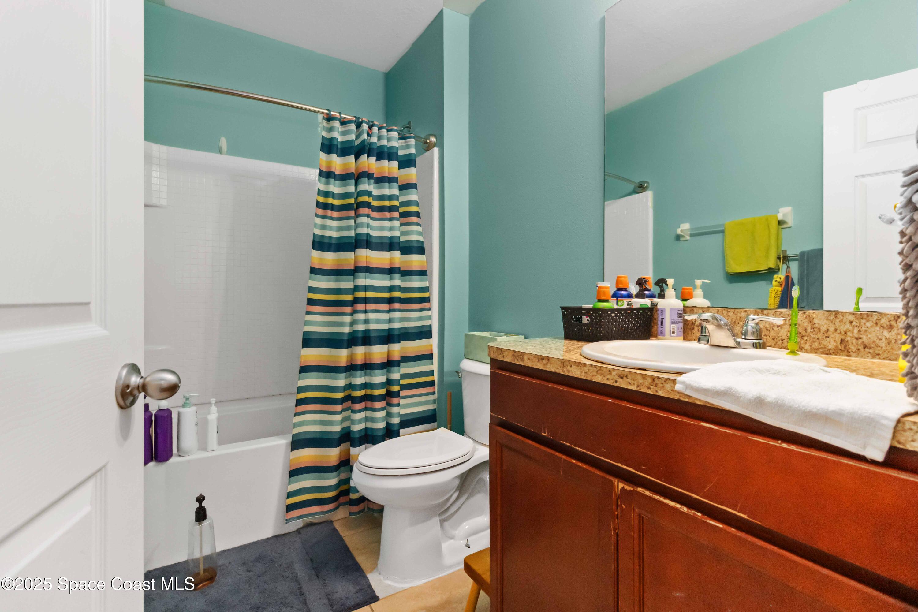 1070 Swiss Pointe Lane Rockledge, FL 32955 - Photo 15 of 29 a bathroom with a sink a toilet and shower