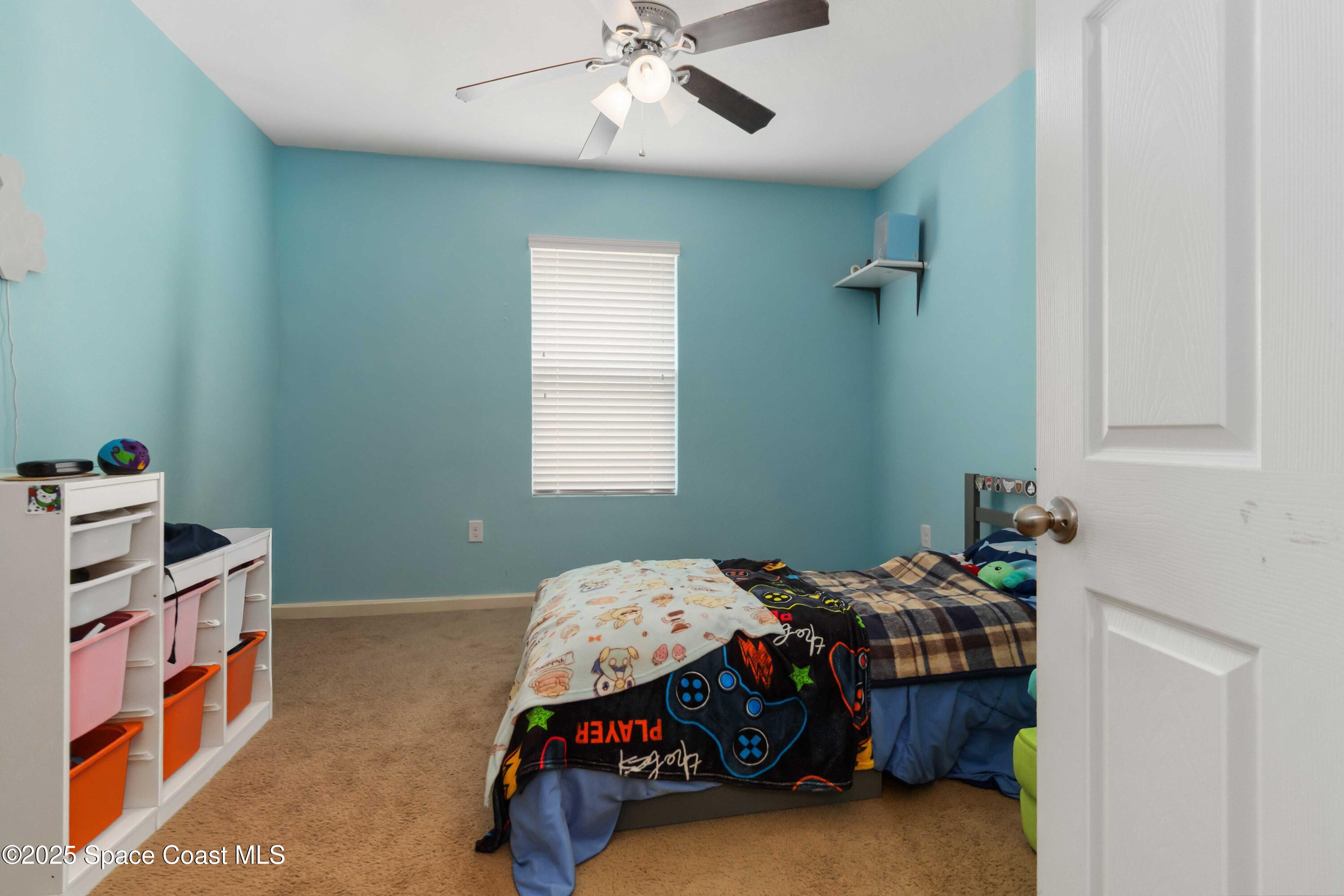 1070 Swiss Pointe Lane Rockledge, FL 32955 - Photo 16 of 29 a bedroom with a bed and a chandelier