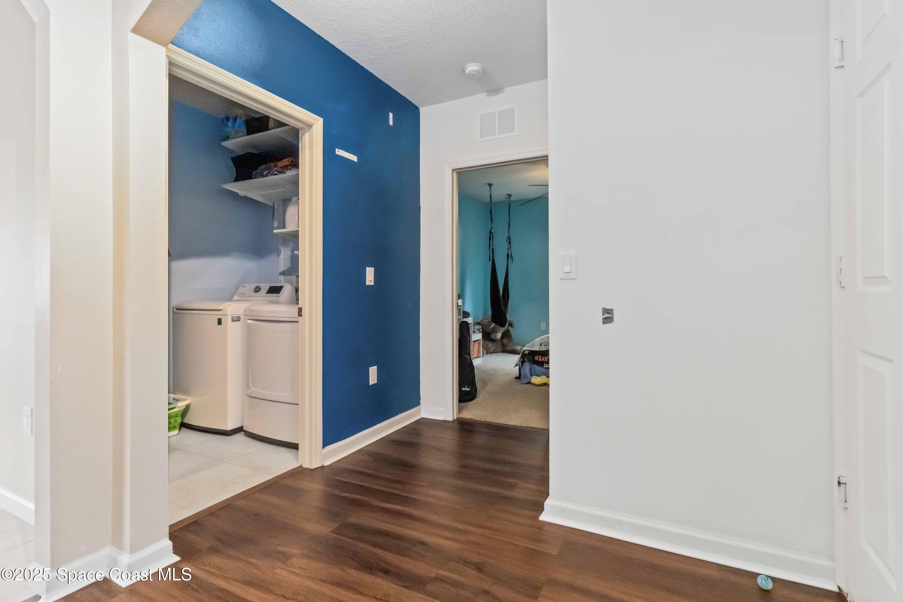 1070 Swiss Pointe Lane Rockledge, FL 32955 - Photo 18 of 29 a view of a hallway with wooden floor closet and livingroom