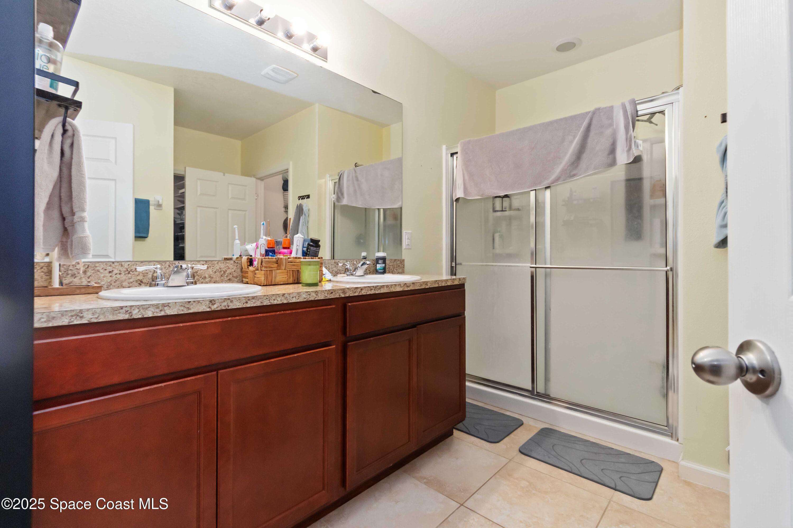 1070 Swiss Pointe Lane Rockledge, FL 32955 - Photo 22 of 29 a bathroom with a sink and a mirror
