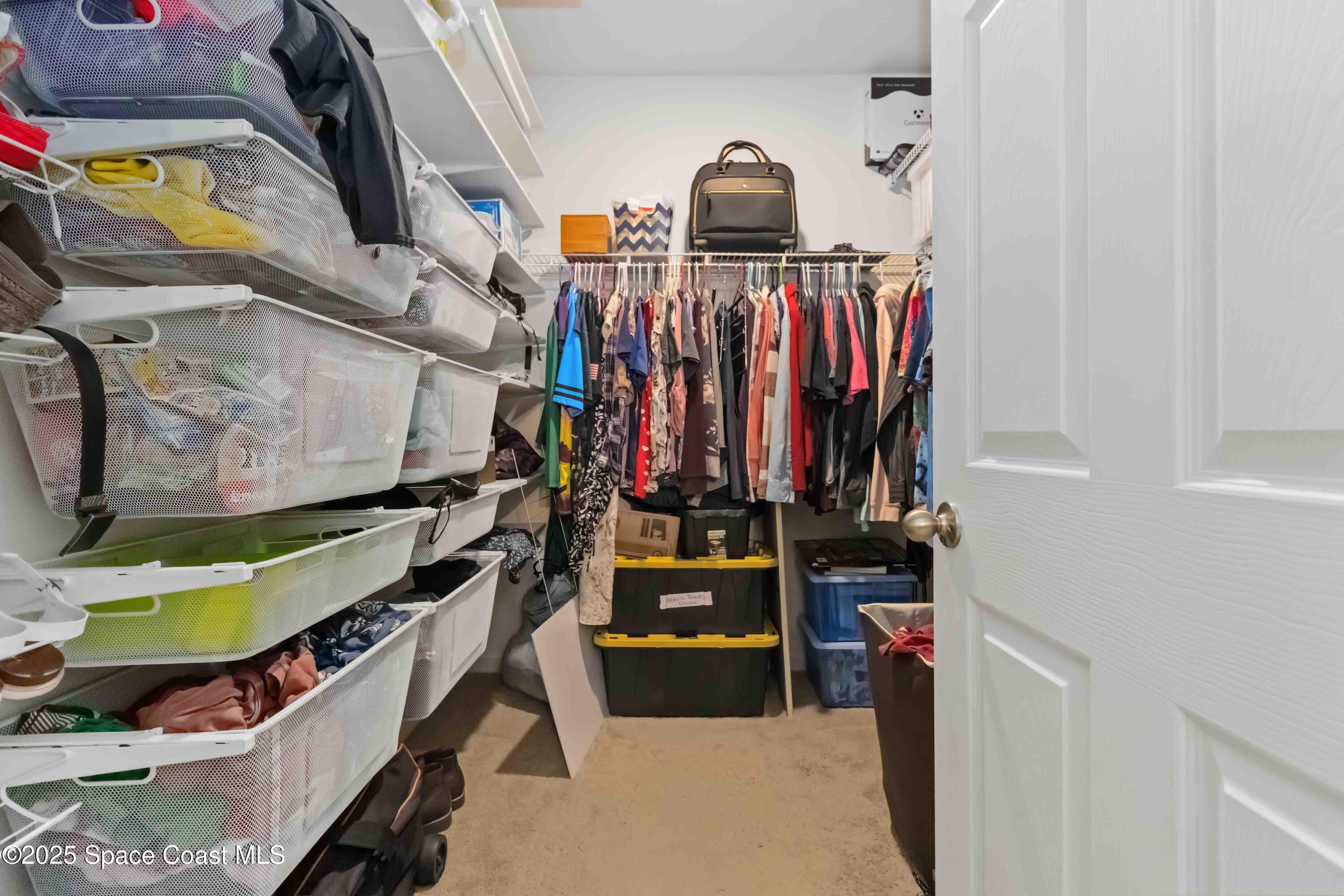 1070 Swiss Pointe Lane Rockledge, FL 32955 - Photo 24 of 29 a view of walk in closet with clothes and shoes