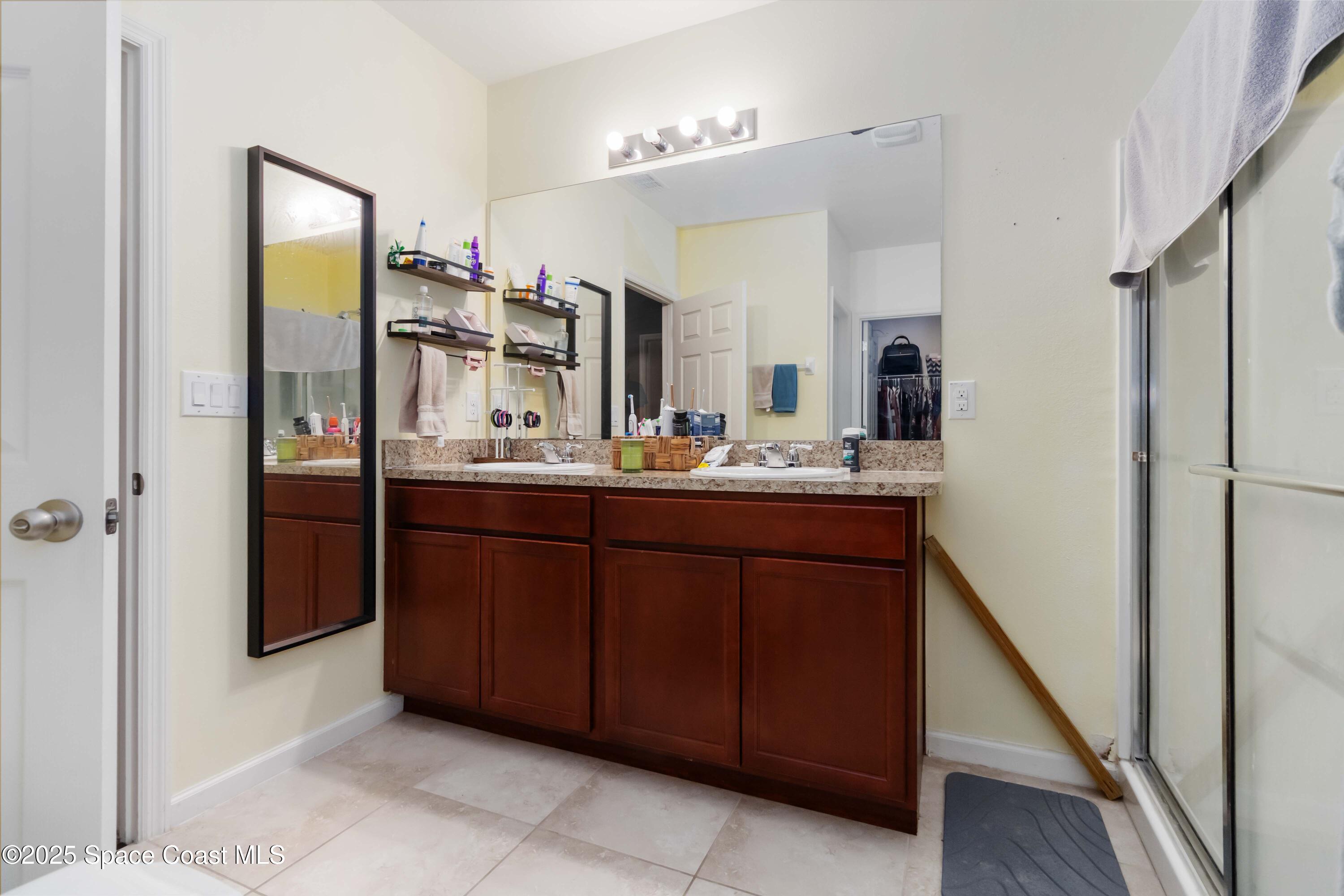 1070 Swiss Pointe Lane Rockledge, FL 32955 - Photo 25 of 29 a bathroom with a sink and a mirror
