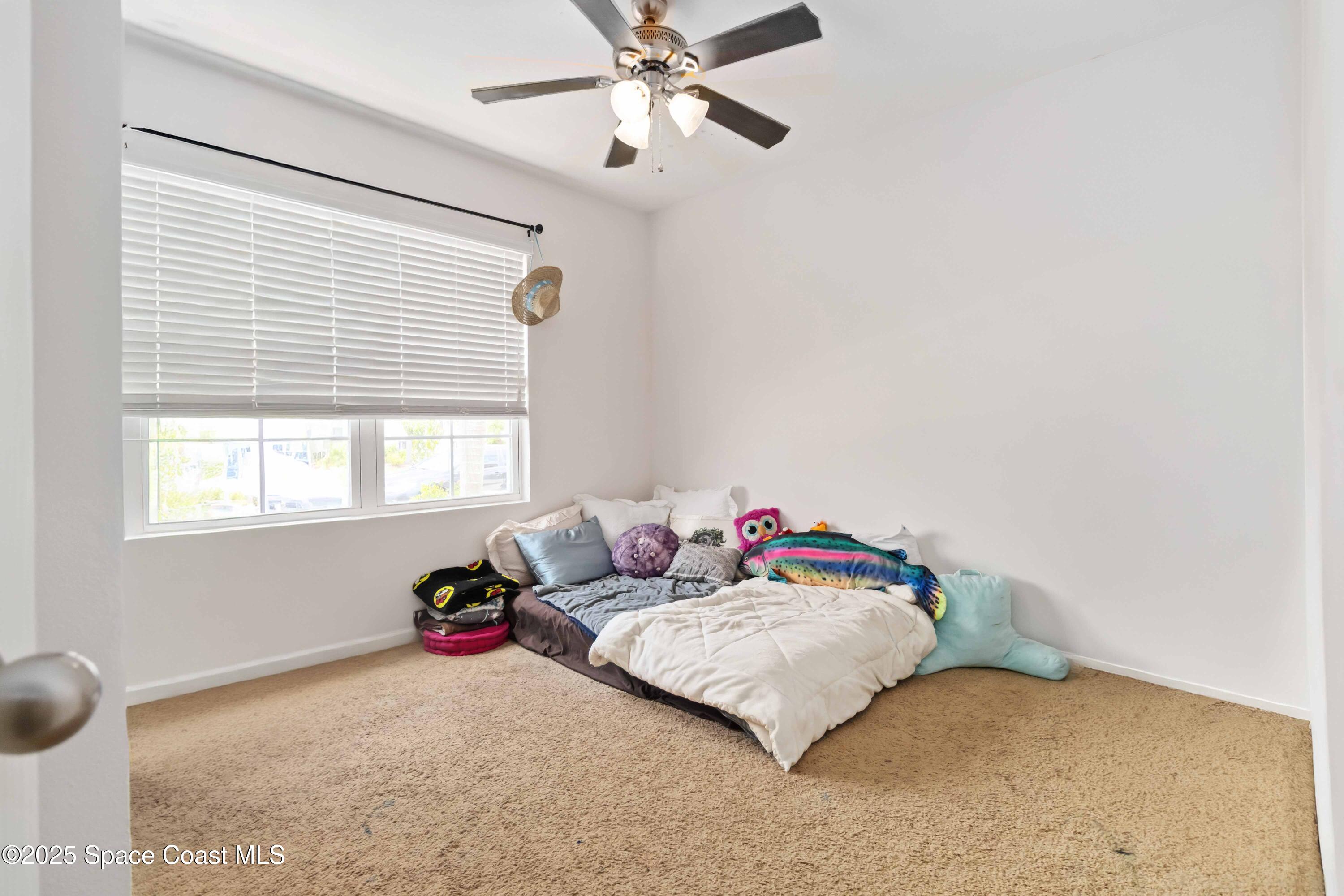 1070 Swiss Pointe Lane Rockledge, FL 32955 - Photo 6 of 29 a bedroom with a bed and window