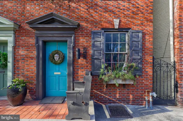 a front view of a house with potted plants