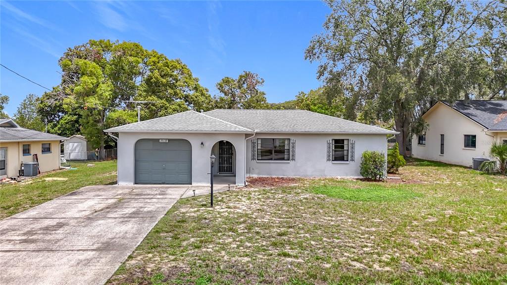 10139 Carrin Road Spring Hill, FL 34608 - Photo 1 of 1 a front view of a house with a yard
