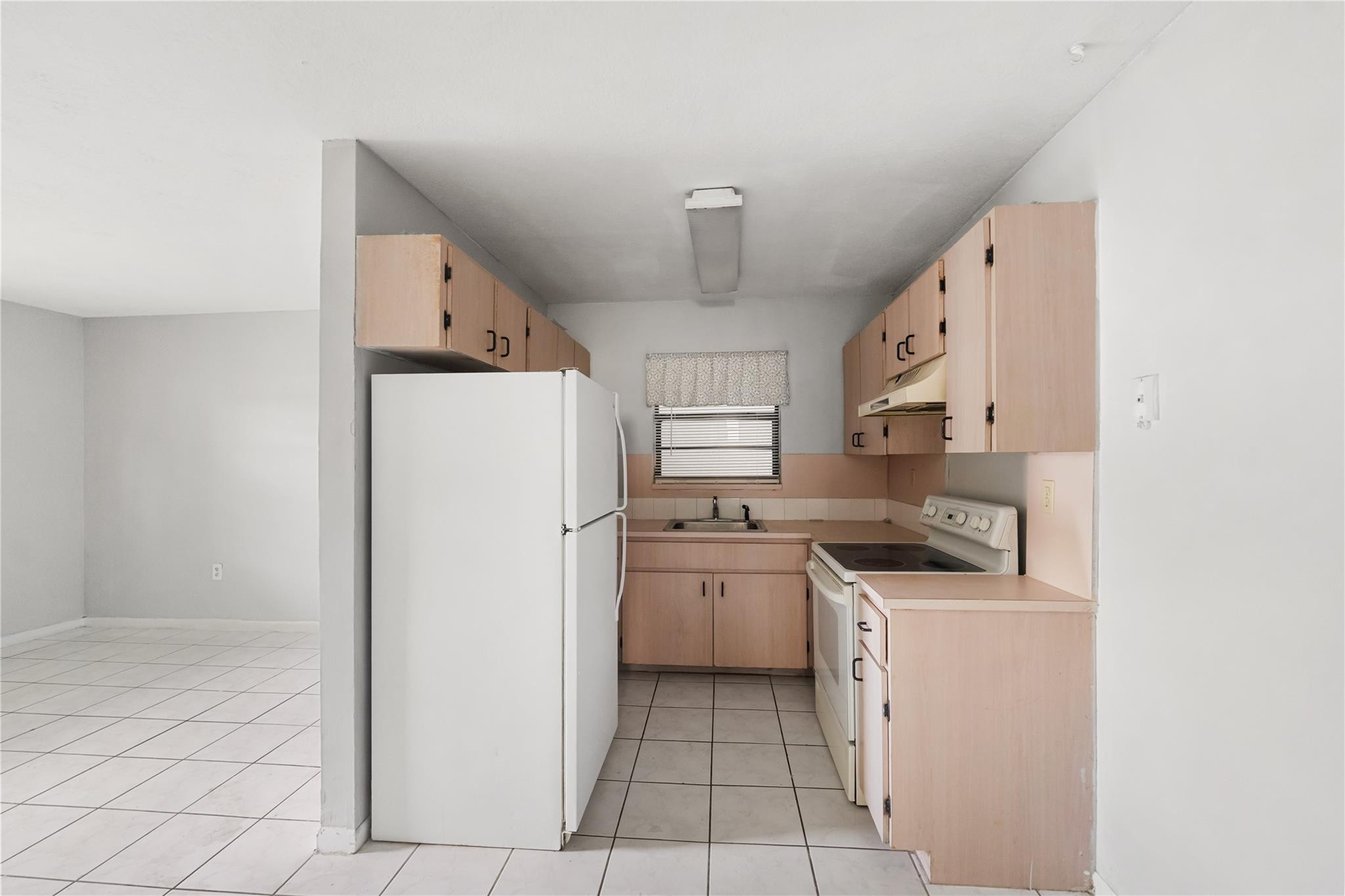 1925 Madison Street, Unit 14 Hollywood, FL 33020 - Photo 3 of 10 a kitchen with stainless steel appliances a refrigerator sink and stove