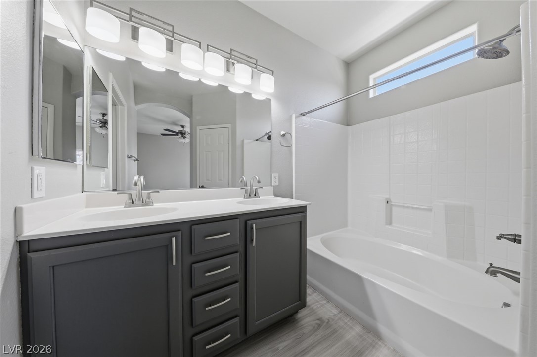 6312 Sandy Ridge Street, Unit 3102 North Las Vegas, NV 89081 - Photo 14 of 31 Dual vanities and a deep soaking tub create a luxurious bathing sanctuary.