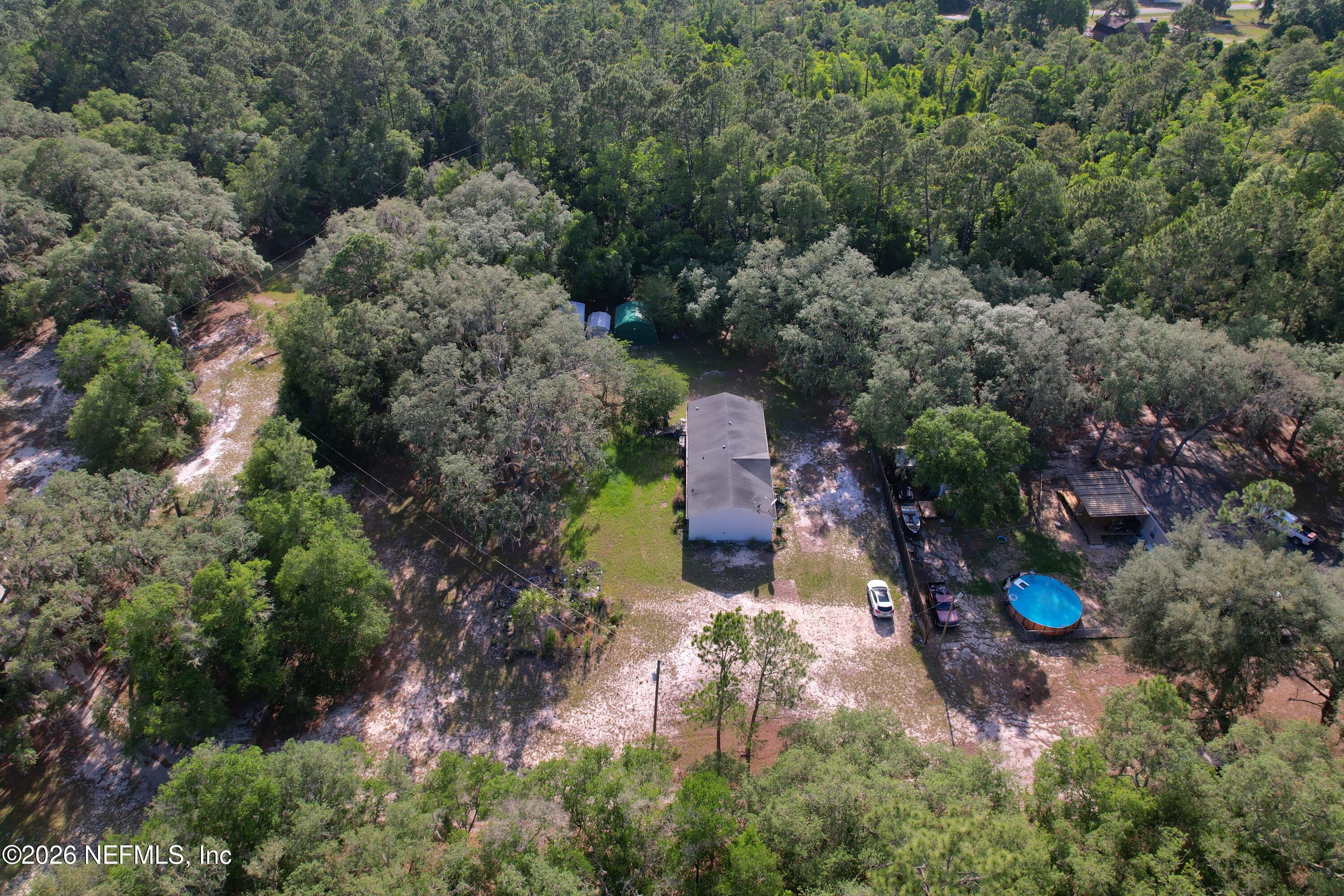 136 Short Pine Road Hawthorne, FL 32640 - Photo 28 of 39 an aerial view of a house with a yard and trees all around