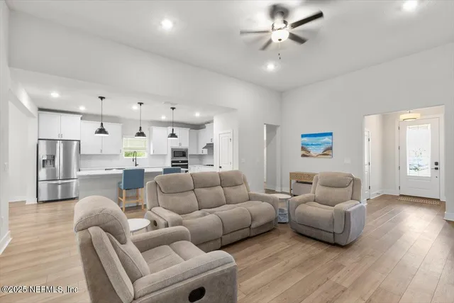 a living room with couches and a coffee table with wooden floor