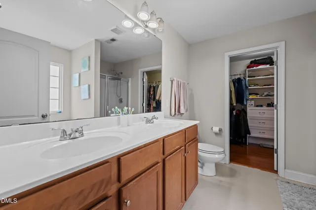 a bathroom with a sink double vanity and a shower