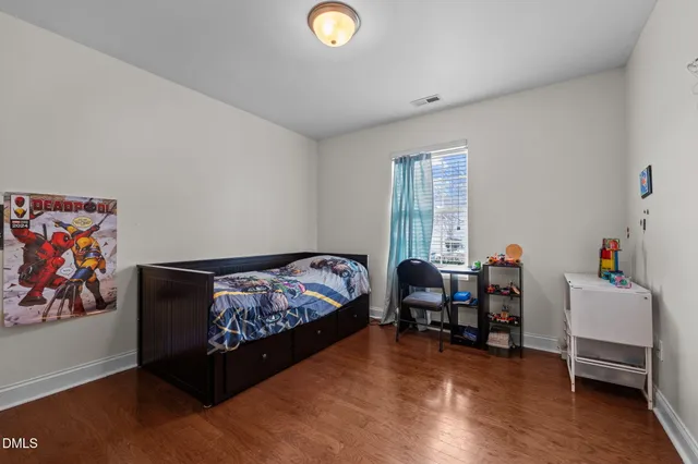 a bedroom with furniture and a window