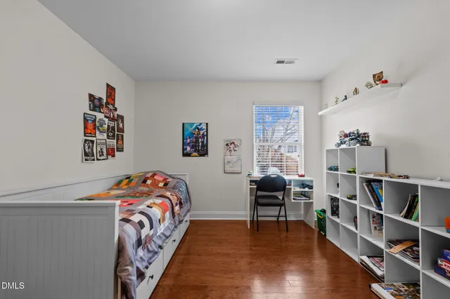 a bedroom with furniture and a wooden floor