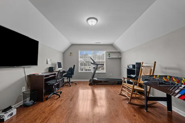 a view of a workspace with furniture and a flat screen tv