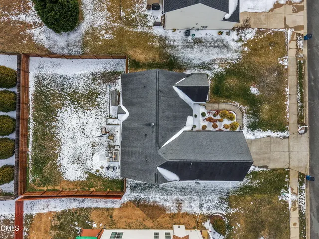 an aerial view of a house with a yard