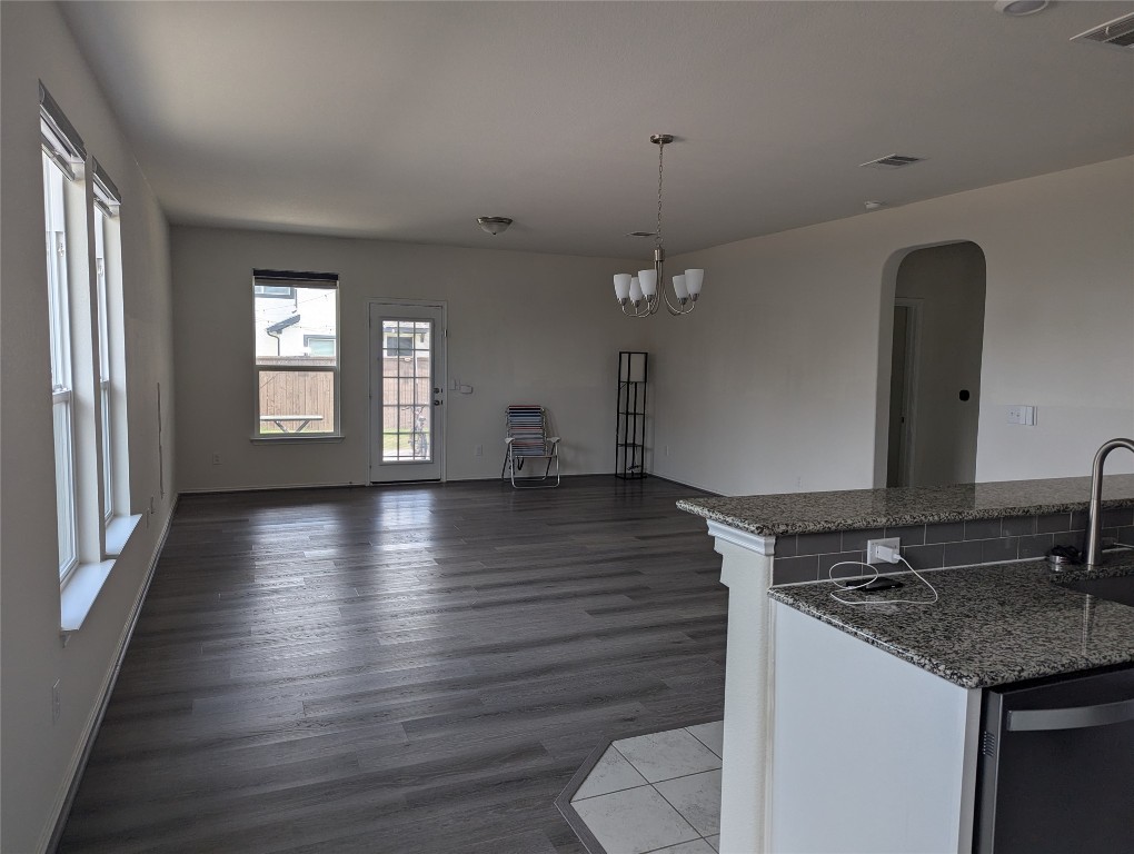 612 Ayinger Lane Austin, TX 78728 - Photo 7 of 13 a view of a kitchen with a sink dishwasher a stove and wooden floor
