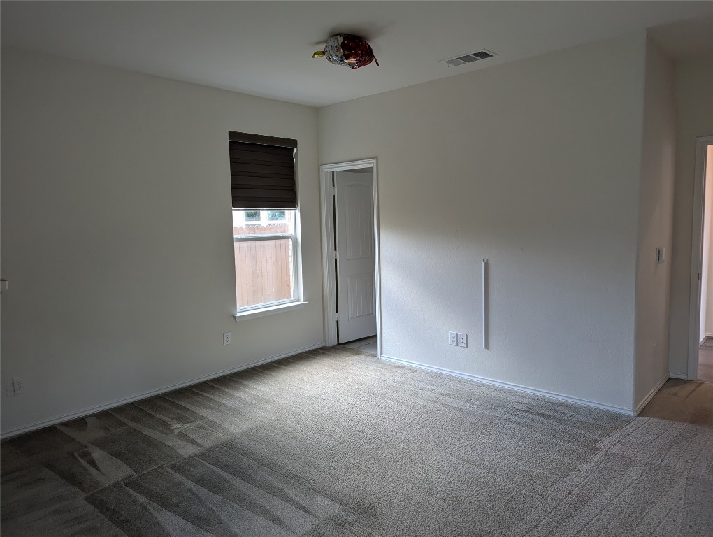 612 Ayinger Lane Austin, TX 78728 - Photo 9 of 13 a view of an empty room with a window