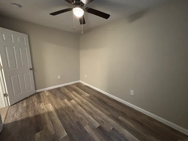 an empty room with a ceiling fan