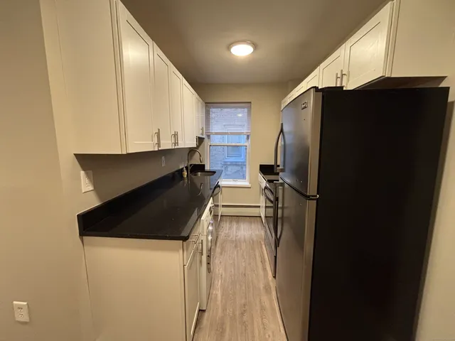 a kitchen with a refrigerator and a stove