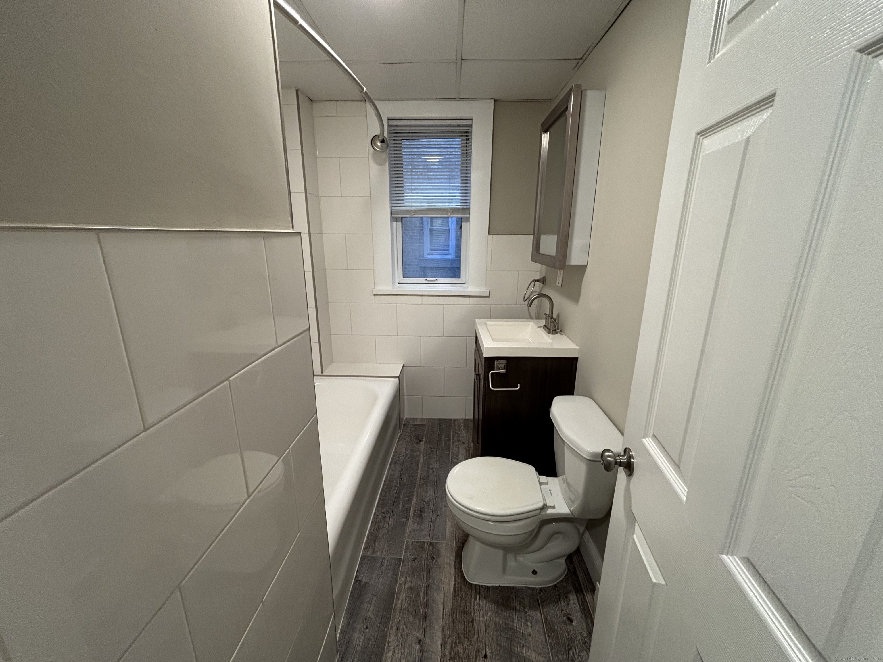 225 Golden Hill Street, Unit 3F Bridgeport, CT 06604 - Photo 8 of 12 a bathroom with a toilet sink and mirror