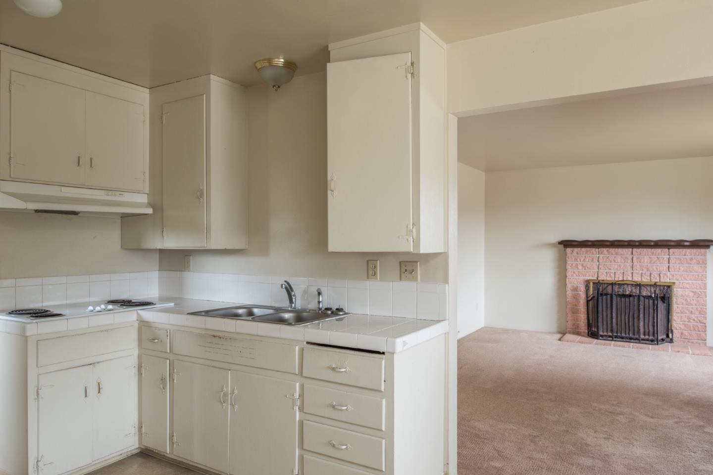 1816 Juarez Street Seaside, CA 93955 - Photo 11 of 27 a kitchen with granite countertop white cabinets and white appliances